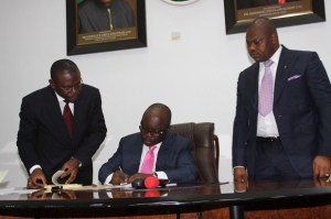  Governor Emmanuel Uduaghan of Delta State ( Middle ) flanked by  Rt. Hon. Victor Ochei Speaker Delta State House of Assembly (Right ) Mr Charles Ajuyah (SAN) Attorney General and Commissioner for  Justice signing into law the Delta State Trafic Management Agency law, signature and outdoor structural and regulatory bill for Inn-keepers and hotel management in Asaba.