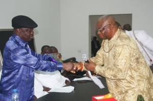 Governor Emmanuel Uduaghan of Delta State (left) receiving a plague from Chief Amos Oyoroko, the President General of Ovwor-Olomu Community