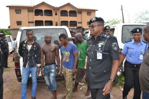 Delta State Commissioner of Police, Mr Ikechukwu Aduba (right) with the arrested suspects of the stolen vehicles refurbishing workshop. Photo Goddy Umukoro