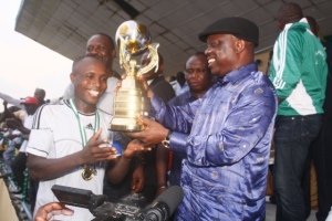 Governor Emmanuel Uduaghan of Delta State (right), presenting the Silver cup to the captain of Royal Eagles club Oleh during the finals of Utuama Peace Cup at Otu-Jeremi Stadium, Ughelli South LGA