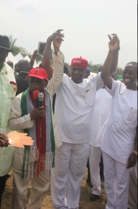 Deputy Governor of Delta State, Prof Amos Utuama SAN (left) and Delta State Governorship Candidate, Senator (Dr) Ifeanyi Okowa (right) holding the hands of former Governorship Aspirant of All Progressive Congress (APC), Chief Fidelis Okenmor Tilije who recently decamp to Peoples` Democratic Party (PDP) in Obiaruku, Ukwani Local Government Area On Monday, February 2, 2015 