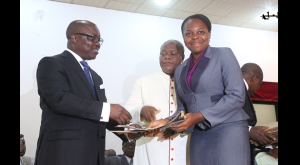 Governor Emmanuel Uduaghan of Delta State (L), presenting Scholarship Award to Miss Abade Peace, during the 2013 First Class Graduate Scholarship Scheme