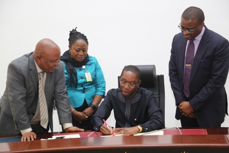 Delta State Governor, Senator Ifeanyi Okopwa (sitting 2nd left); Speaker, State House of Assembly, Rt Hon Monday Igbuya (left); Clerk of the House, Mrs Lyna Ochulor (2nd left) and Commissioner for Finance Mr David Edevbie as the signs the 2016 Appropriation Bill into law in Asaba. 