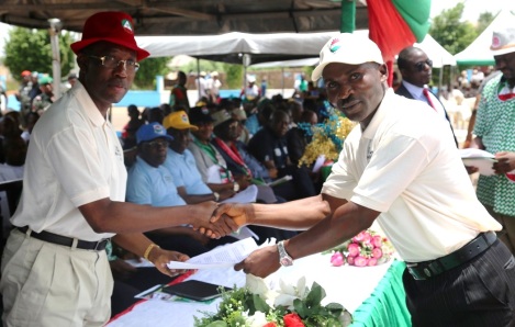 Delta State Governor, Senator Ifeanyi Okowa (left), receiving a copy of address from the State NUT Chairman, Comrade Jonathan Jemirugbe, representing the State NLC, Comrade David Ofoeyeno during the 2016 May Day celebration in Asaba.