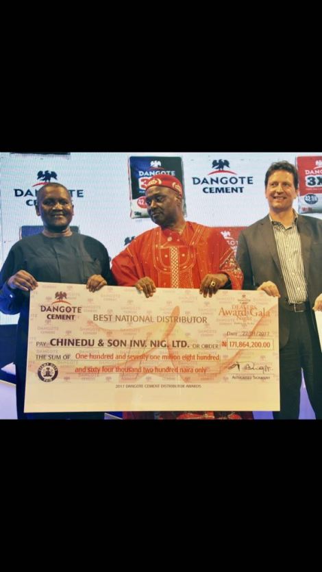 THE DIRECTOR, CHINEDU & SONS INVESTMENT NIGERIA LIMITED, CHIEF CHINEDU EZENYILI (IDE OKO) RECEIVING HIS AWARD FROM THE PRESIDENT DANGOTE GROUP (DANGOTE CEMENT), ALHAJI ALIKO DANGOTE (GCON), AS THE SOUTH-SOUTH BEST CUSTOMER OF THE YEAR FOR DANGOTE CEMENT. 